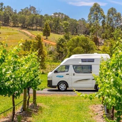 Cheapa Camper rental campervan driving through vineyard